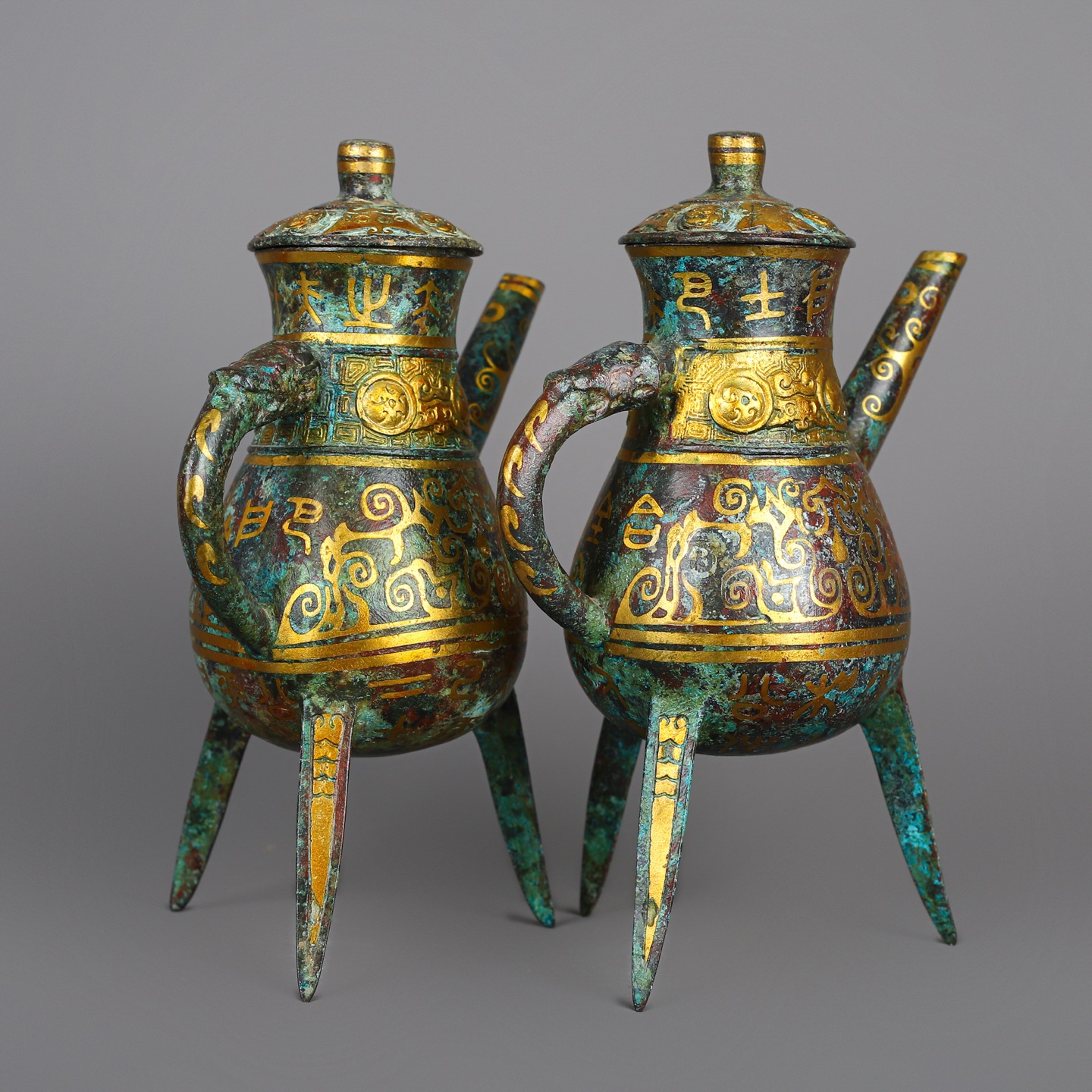 Han Dynasty Pair of bronze and gold three legged wine bottles