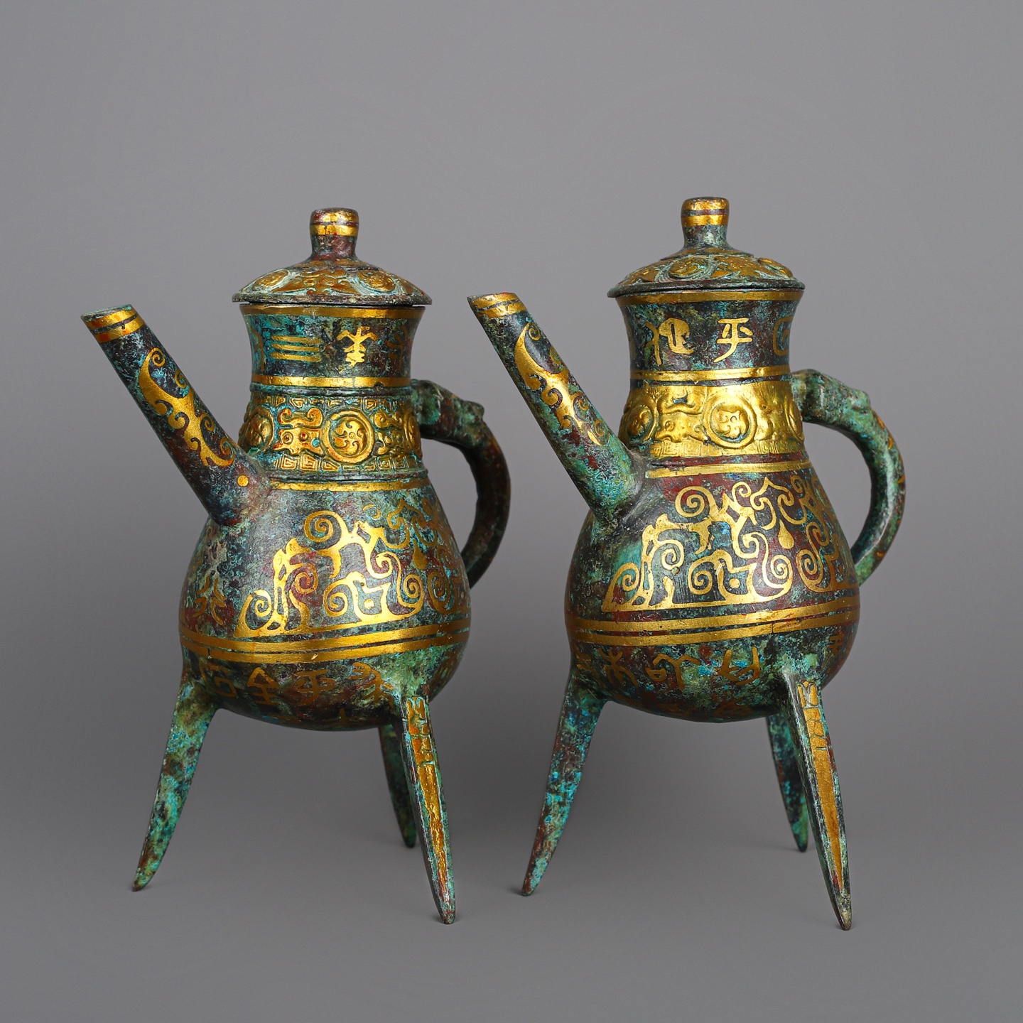 Han Dynasty Pair of bronze and gold three legged wine bottles