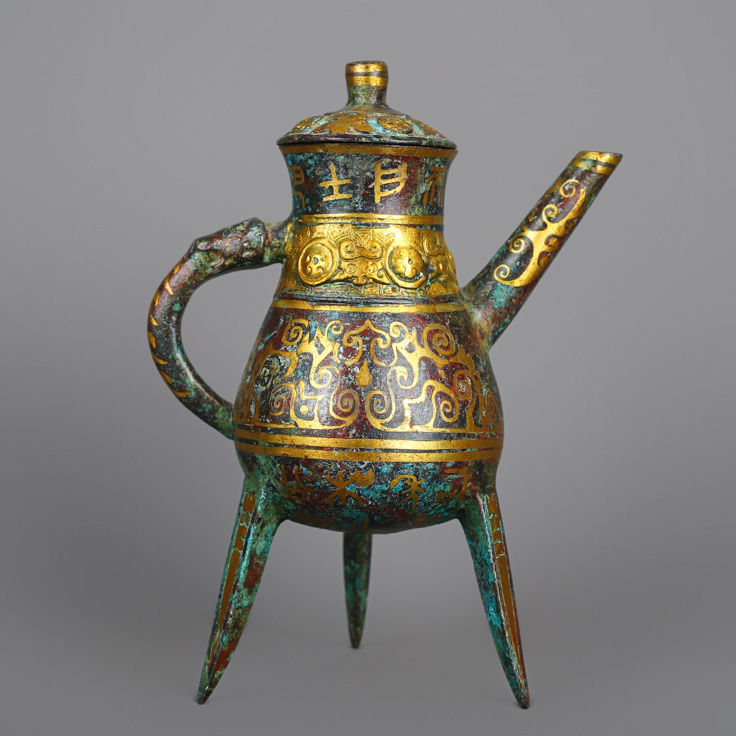 Han Dynasty Pair of bronze and gold three legged wine bottles