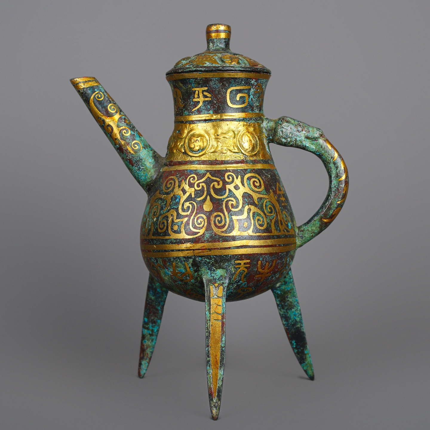 Han Dynasty Pair of bronze and gold three legged wine bottles