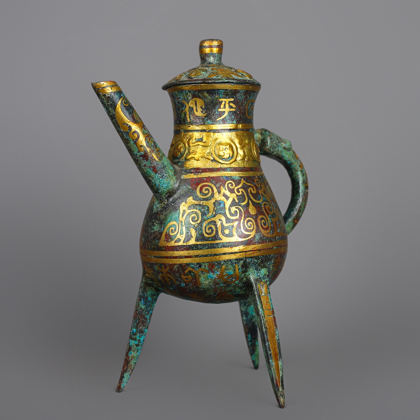 Han Dynasty Pair of bronze and gold three legged wine bottles