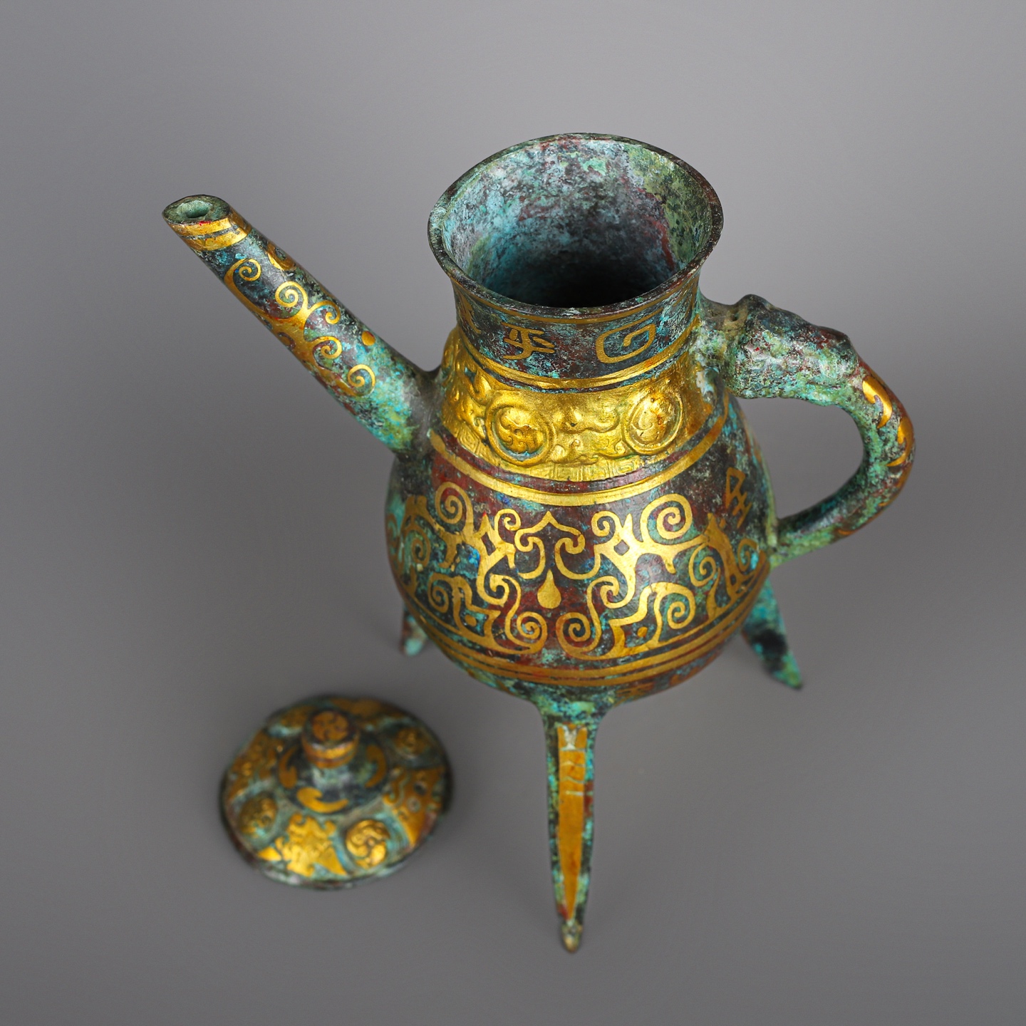 Han Dynasty Pair of bronze and gold three legged wine bottles