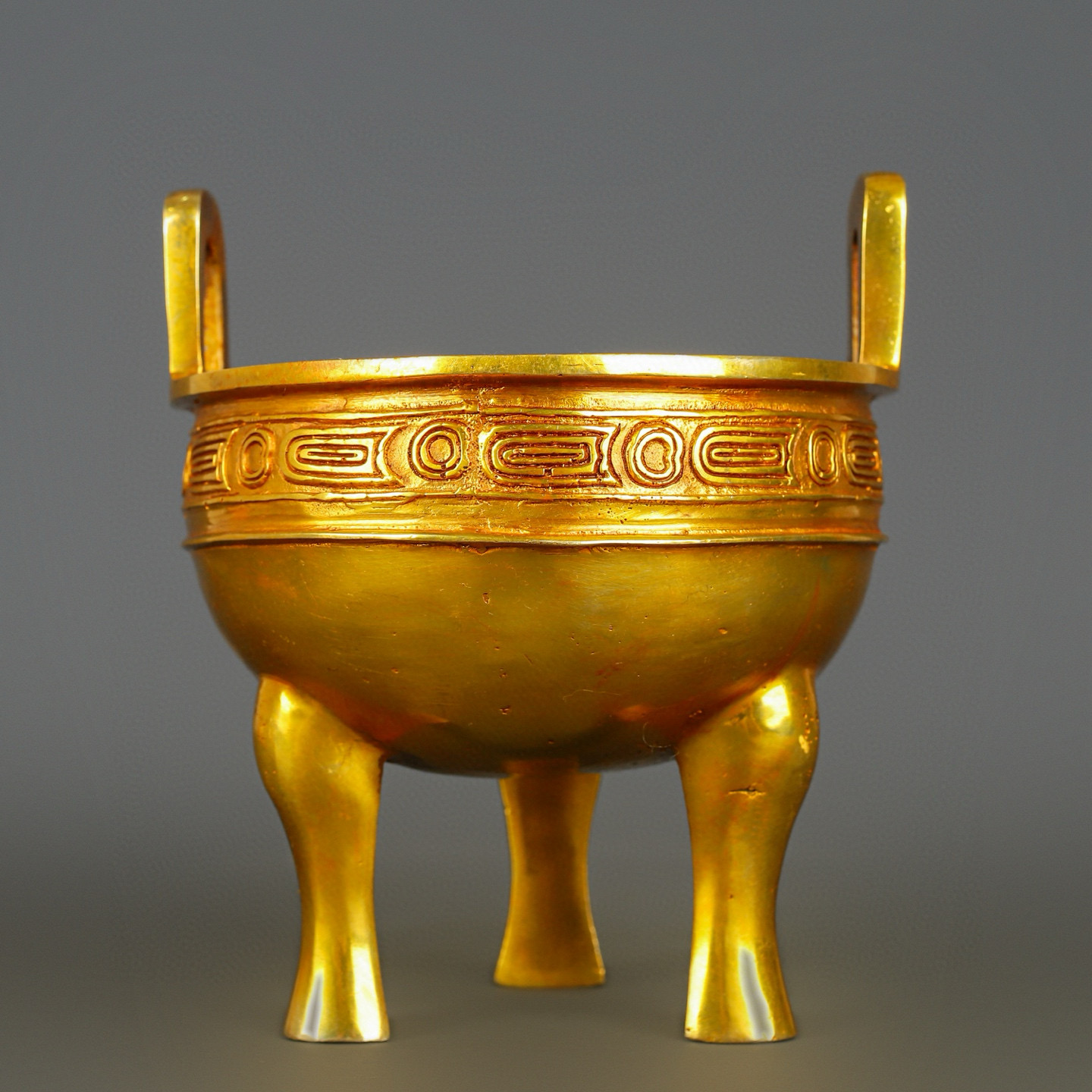 Han Dynasty gilt bronze and gold haired male tripod