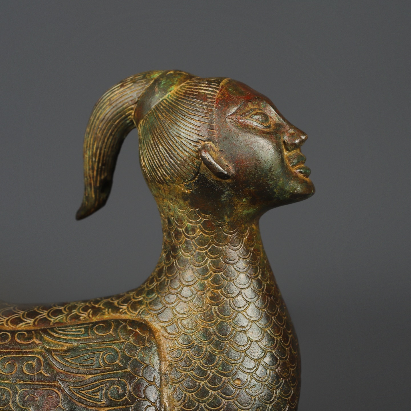 Zhou Dynasty Bronze human faced long tailed beast