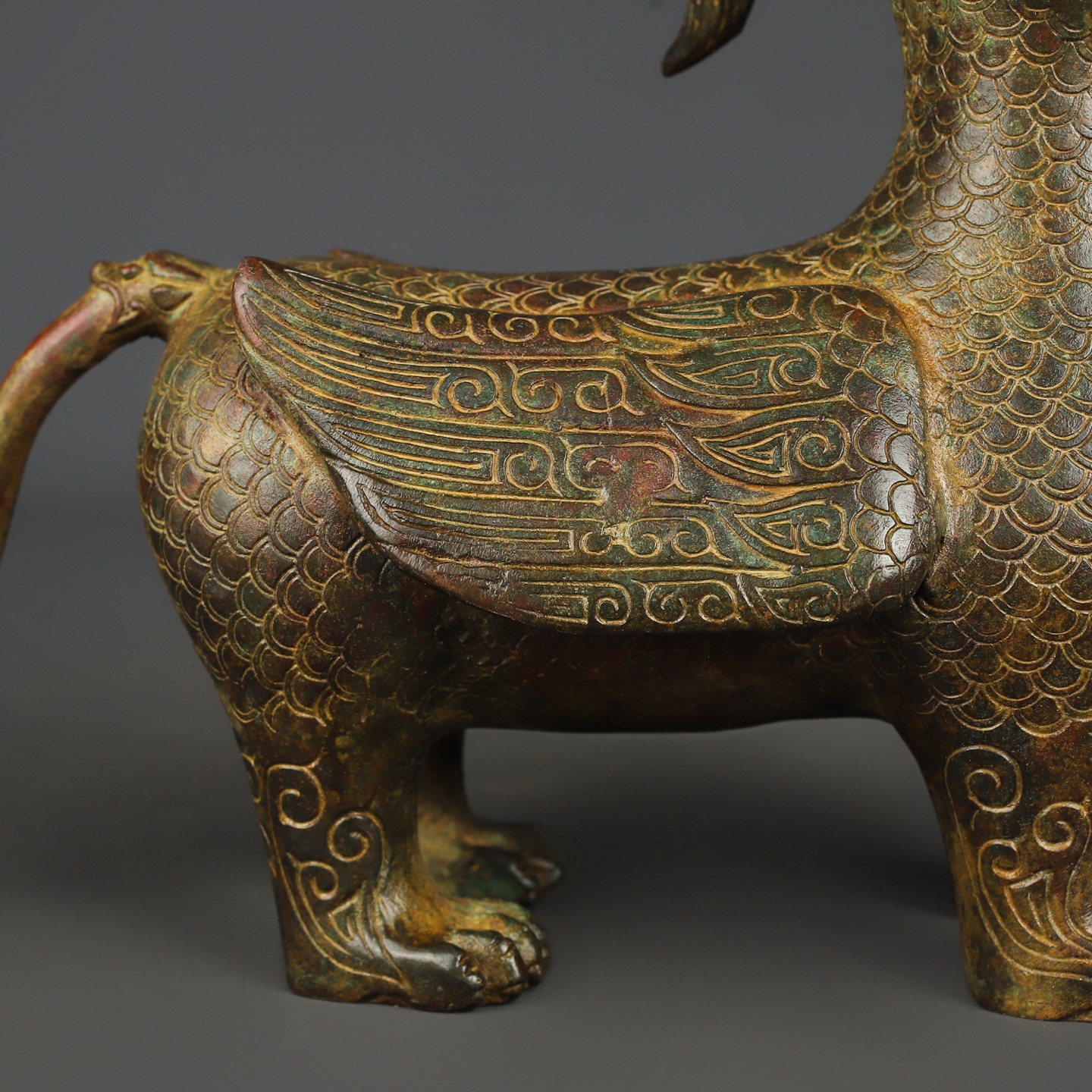Zhou Dynasty Bronze human faced long tailed beast