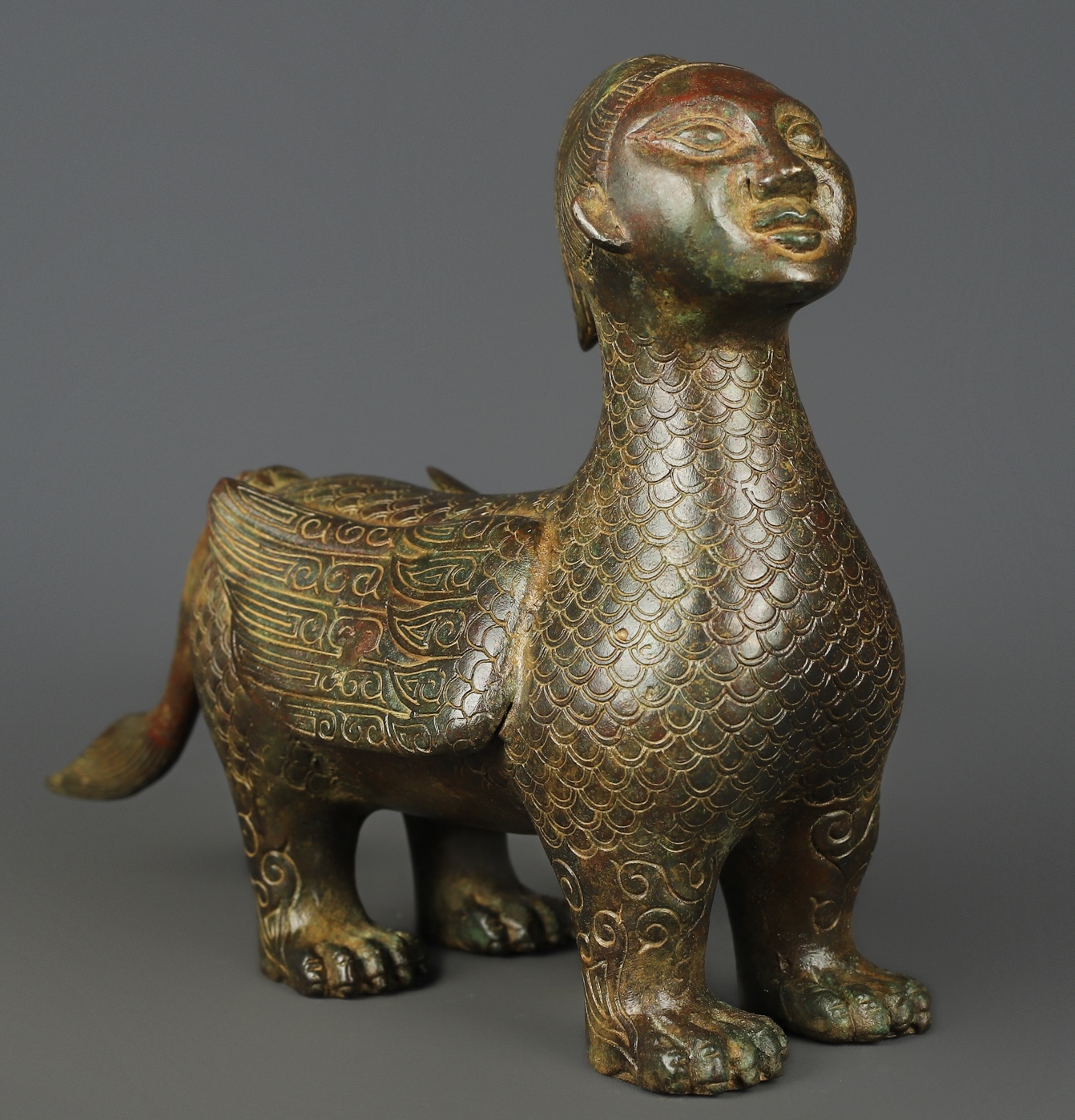 Zhou Dynasty Bronze human faced long tailed beast