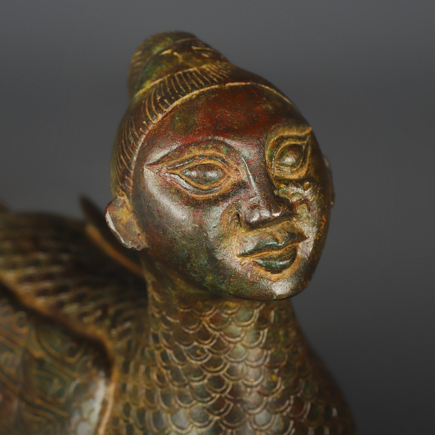 Zhou Dynasty Bronze human faced long tailed beast