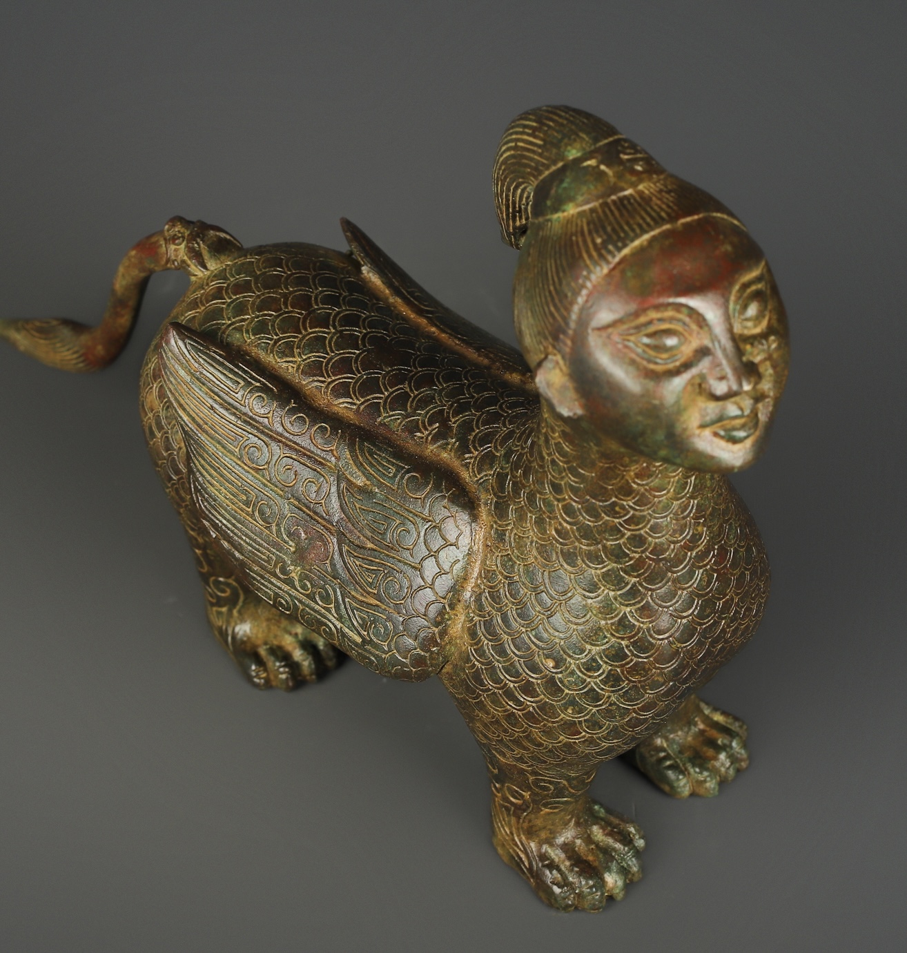 Zhou Dynasty Bronze human faced long tailed beast