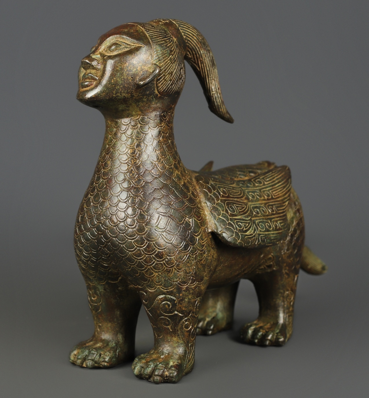 Zhou Dynasty Bronze human faced long tailed beast